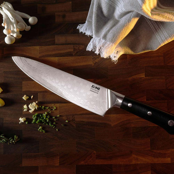 ZLINE Japanese Damascus chef knife on cutting board with chopped food