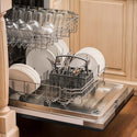 Built-in top control dishwasher with dishes and utensils on bottom rack and glassware on top rack